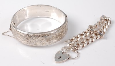 Lot 460 - A silver and engraved hinged bangle, with...