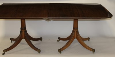 Lot 2500 - A mahogany triple pillar pedestal dining table,...