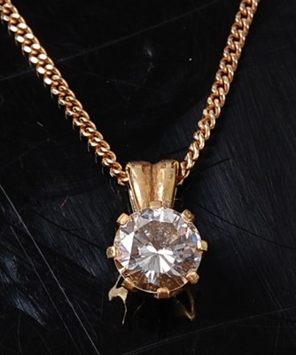 Lot 2243 - A yellow metal diamond single stone pendant,...