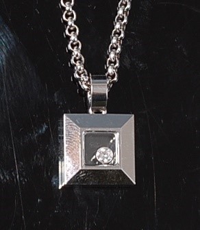 Lot 2268 - An 18ct white gold Happy Diamond pendant by...