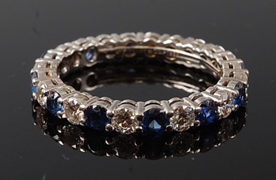 Lot 2242 - A white metal, sapphire and diamond full hoop...