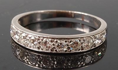 Lot 2238 - A white metal diamond eleven-stone half hoop...