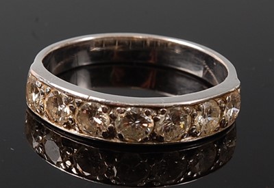 Lot 2241 - A white metal diamond seven-stone half hoop...