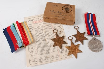 Lot 26 - A group of four WW II medals, to include...