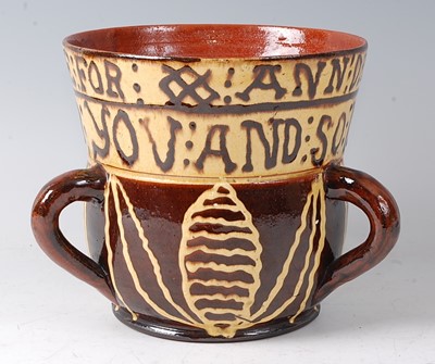 Lot 2060 - A Wrotham style brown and yellow slipware tyg,...