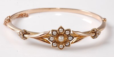 Lot 2277 - A yellow metal oval hinged hollow bangle with...