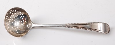 Lot 2182 - A George III silver sifting spoon, of small...
