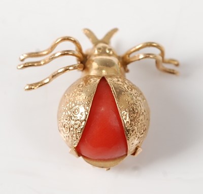 Lot 2255 - A yellow metal coral beetle brooch, comprising...
