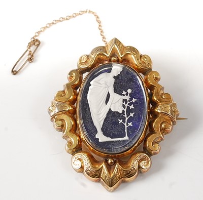 Lot 2256 - A yellow metal engraved scrollwork oval brooch,...