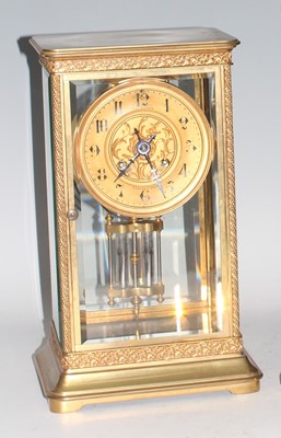 Lot 2458 - A circa 1900 gilt brass four glass clock by...