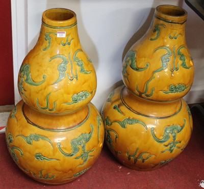 Lot 133 - A pair of Chinese double gourd floor vases,...
