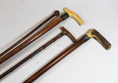 Lot 180 - An early 20th century ivory handled walking...
