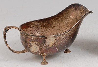 Lot 106 - An Art Deco silver sauceboat, having all-over...