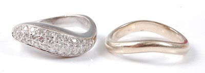 Lot 2508 - A white metal diamond three row curved band,...