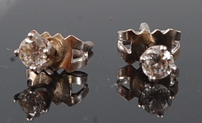 Lot 2511 - A pair of white metal diamond stud earrings,...