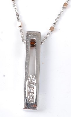 Lot 2515 - A 9ct white gold diamond bar pendant,...