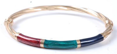 Lot 2533 - A yellow metal twist hollow hinged bangle,...