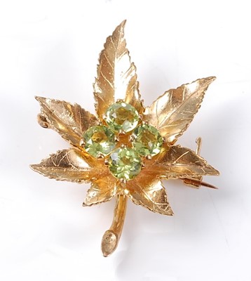 Lot 2524 - A 9ct yellow gold Maple leaf brooch, having a...