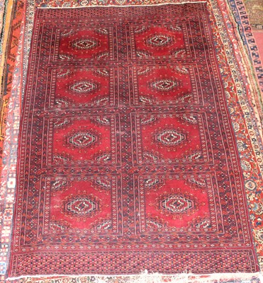 Lot 5 - * An Afghan woollen Baluch rug, the red ground...