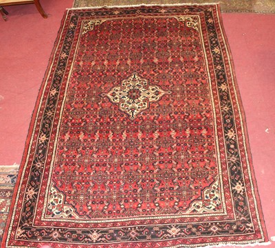 Lot 14 - * A Persian woollen Hamadan rug, the red...