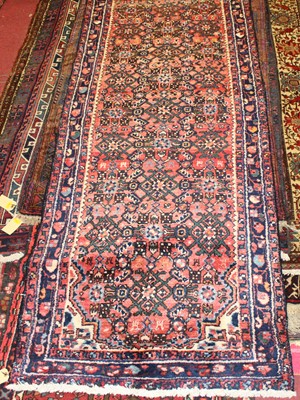 Lot 16 - * A Persian woollen Hamadan hall runner, the...
