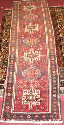 Lot 19 - * A Turkish woollen hall runner, the red...