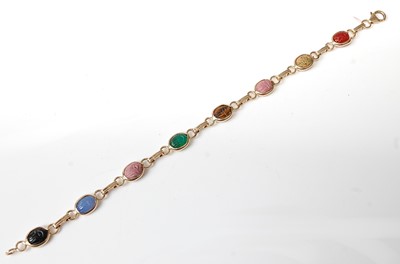 Lot 2567 - A yellow metal multi-stone bracelet, featuring...