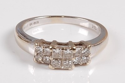 Lot 2562 - A white metal diamond dress ring, comprising...