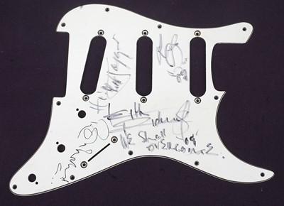 Lot 556 - A guitar scratch plate bearing the signatures...