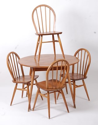 Lot 403 - A 1960s Ercol light elm oval kitchen table,...