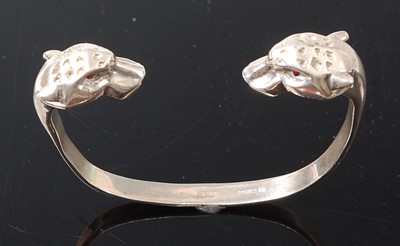 Lot 2599 - A sterling silver leopard head torque bangle,...