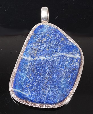 Lot 2621 - A sterling silver lapis lazuli pendant, the...