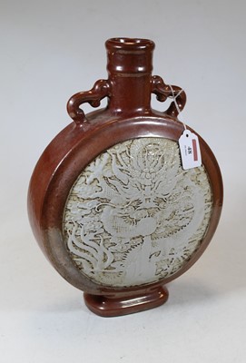Lot 48 - A Chinese stoneware moon flask, the red lustre...
