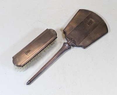 Lot 279 - An Art Deco silver backed hand mirror, having...
