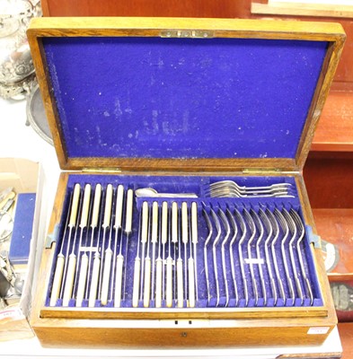 Lot 284 - A 1920s oak cased 12-place setting canteen of...