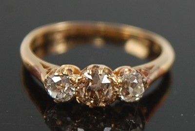 Lot 2637 - A yellow metal diamond three-stone ring,...