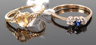 Lot 369 - A 9ct gold, sapphire and diamond three stone...
