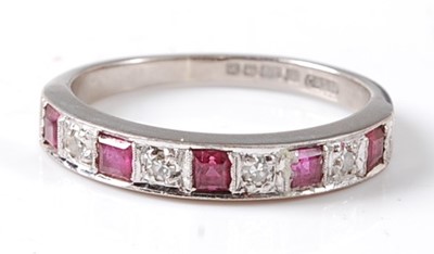 Lot 2695 - An 18ct white gold ruby and diamond half hoop...