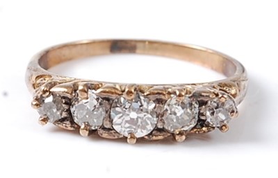 Lot 2696 - A yellow metal diamond five stone half hoop...