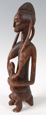 Lot 63 - * A maternity figure, carved as a seated...