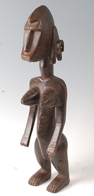 Lot 67 - * An ancestor figure, carved as a nude female...