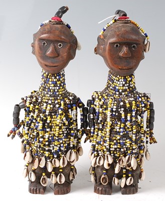 Lot 76 - * A pair of glass trade bead and cowrie shell...