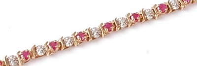 Lot 2793 - A 9ct yellow and white gold, ruby and white...