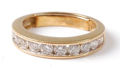 Lot 2795 - A yellow metal diamond half hoop eternity ring,...
