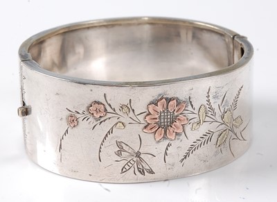 Lot 2805 - A Victorian white metal hinged bangle, having...