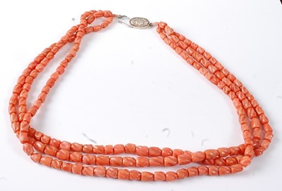 Lot 2814 - A carved coral three-string necklace, having...