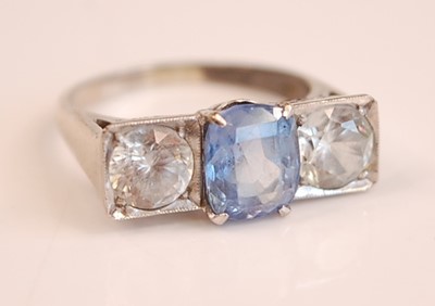 Lot 3087 - A white metal, sapphire and zircon three-stone...