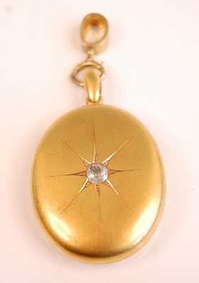 Lot 3086 - A yellow metal oval diamond set locket,...
