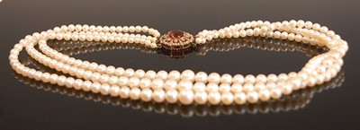 Lot 3095 - A three-row cultured pearl necklet, comprising...