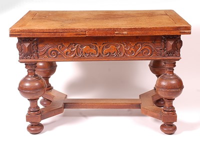 Lot 3328 - An antique continental oak drawleaf refectory...